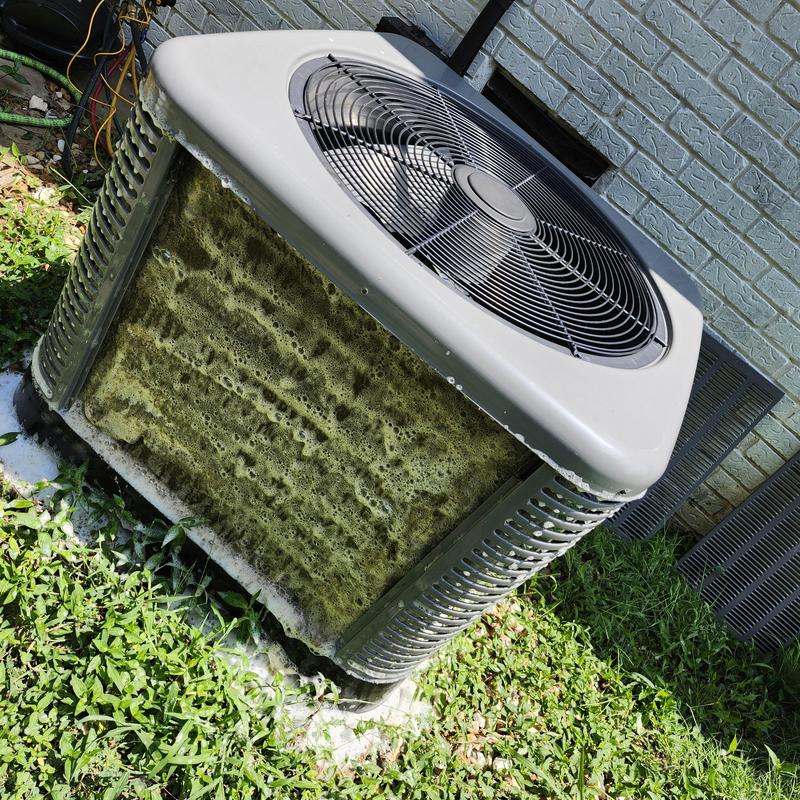 Condenser coil of air conditioner covered in thick foam cleaning foam Condenser coil of air conditioner covered in thick foam cleaning foam