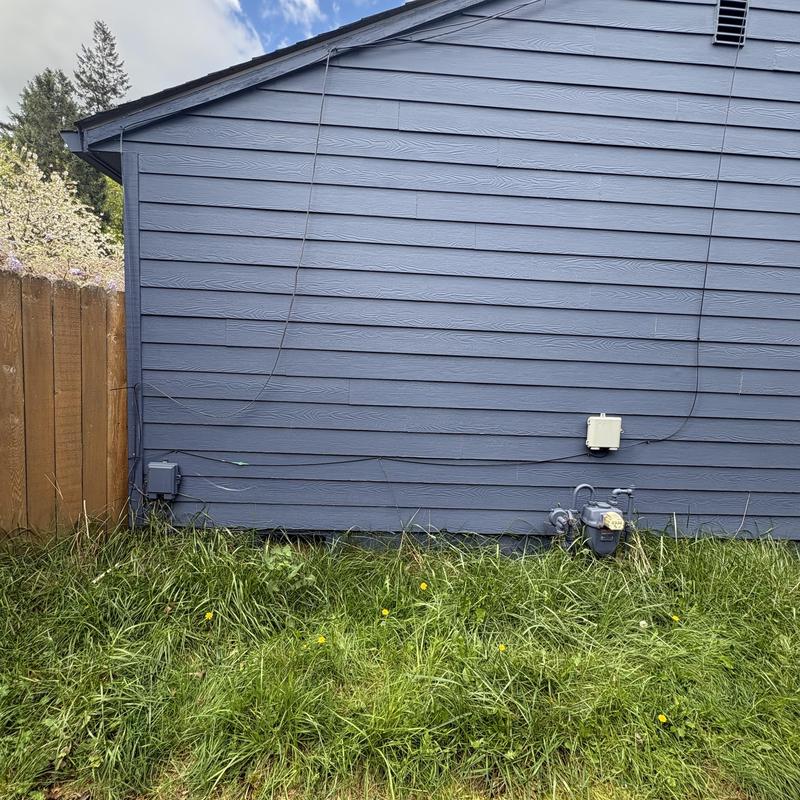Natural gas meter and utility boxes on house exterior Natural gas meter and utility boxes on house exterior