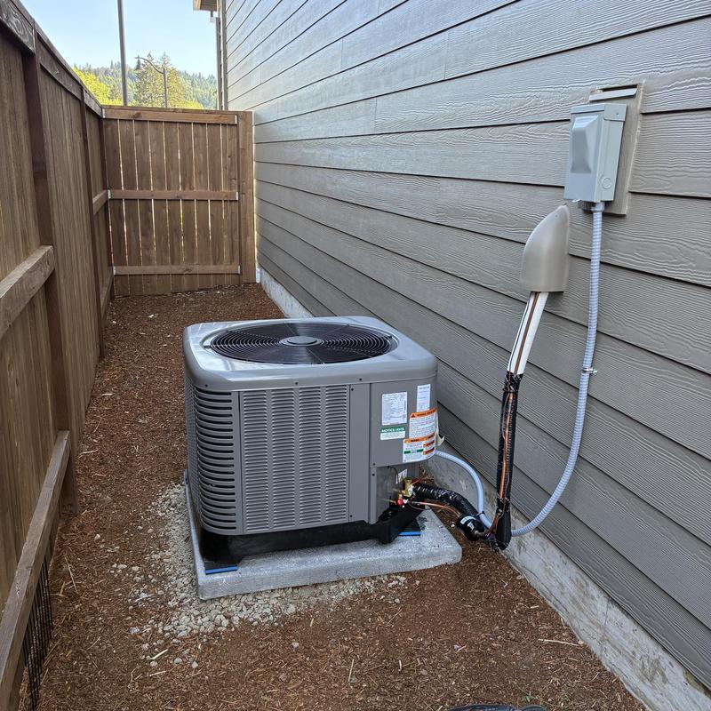 Ruud air conditioning system installed outside home Ruud air conditioning system installed outside home