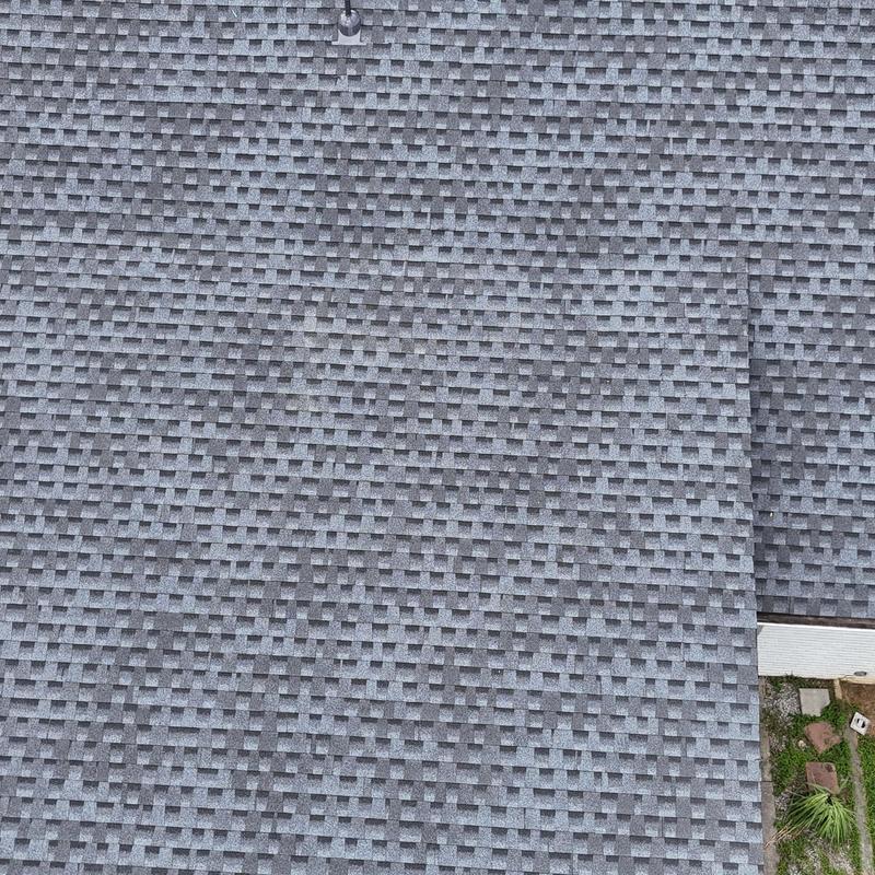 Gray asphalt shingle roof installation on residential home