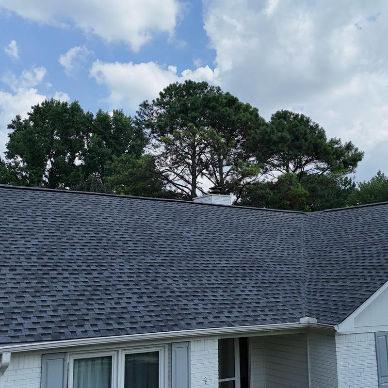 Asphalt shingle roof with clean gutters on home