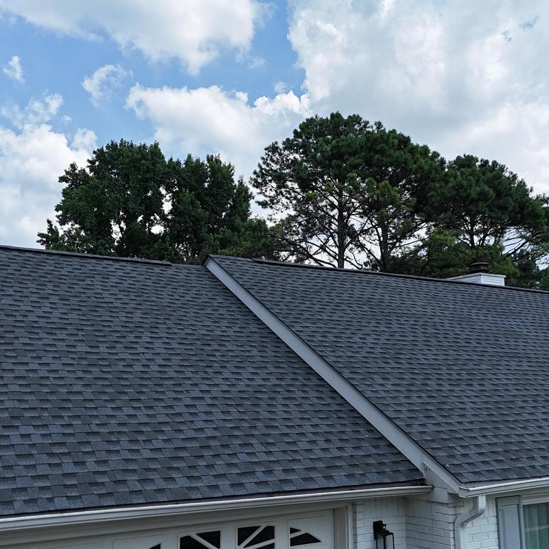 Asphalt shingle roof with clean gutters and valleys