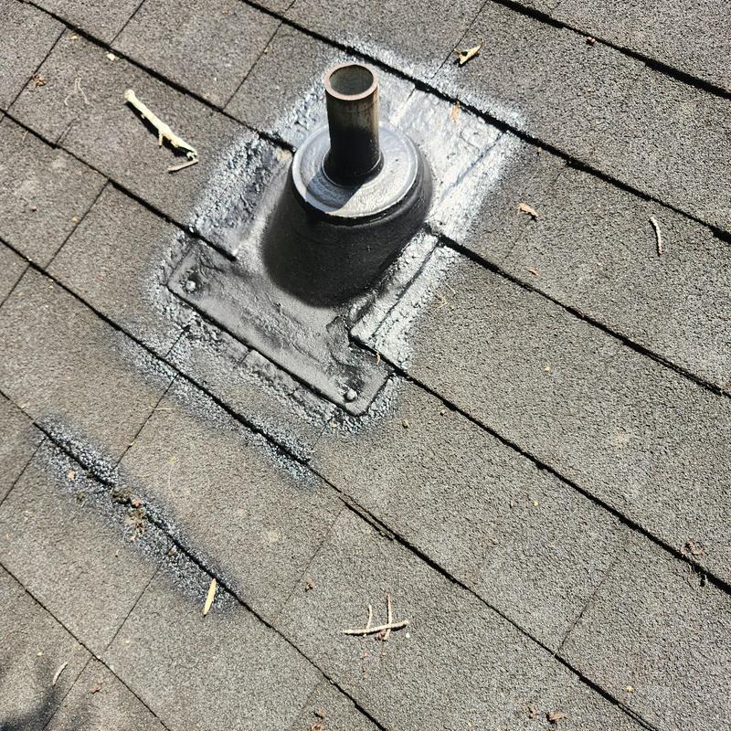 Roof vent boot on aged shingle roof with leak repair area Roof vent boot on aged shingle roof with leak repair area