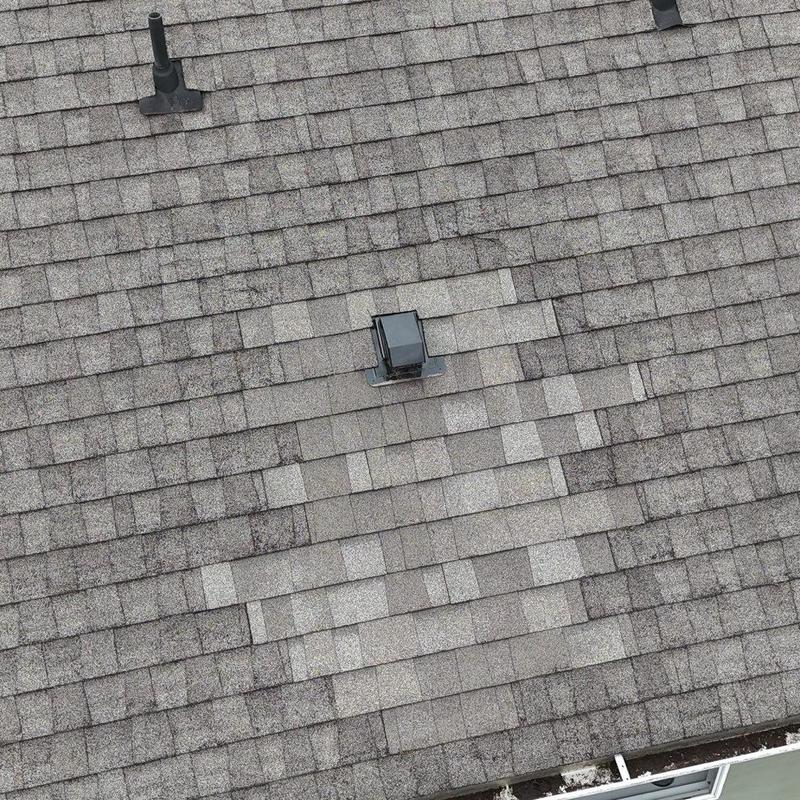 Asphalt shingle roof with vent pipe and patch