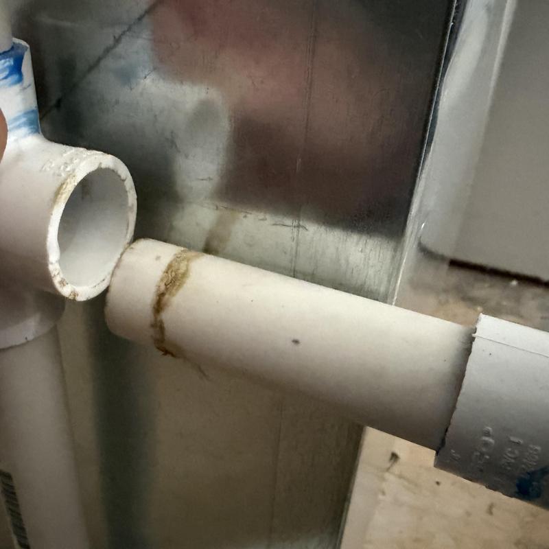 PVC condensate drain with leaking unglued joint PVC condensate drain with leaking unglued joint