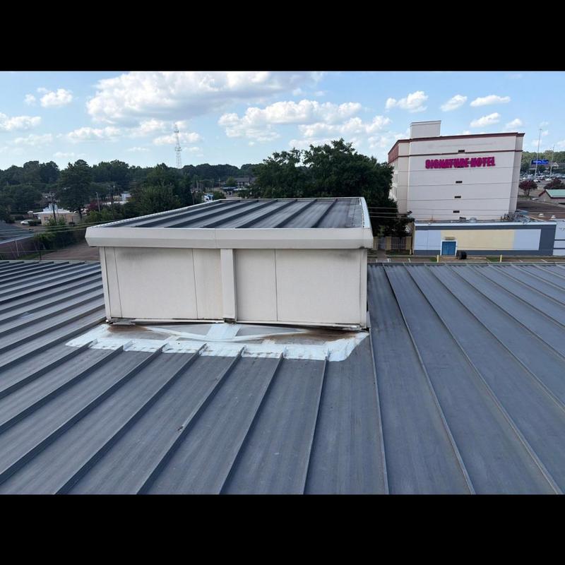 Standing seam metal roof with rooftop duct flashing
