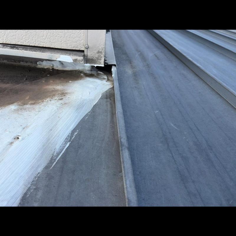 Standing seam metal roof sealant and flashing detail