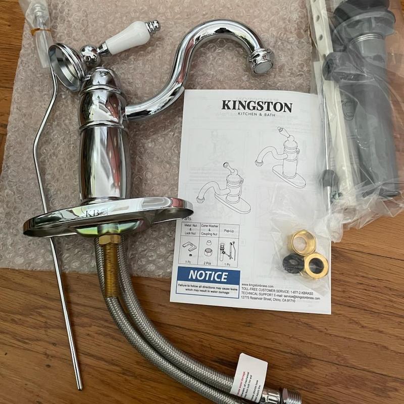 Bathroom sink faucet with installation parts on floor