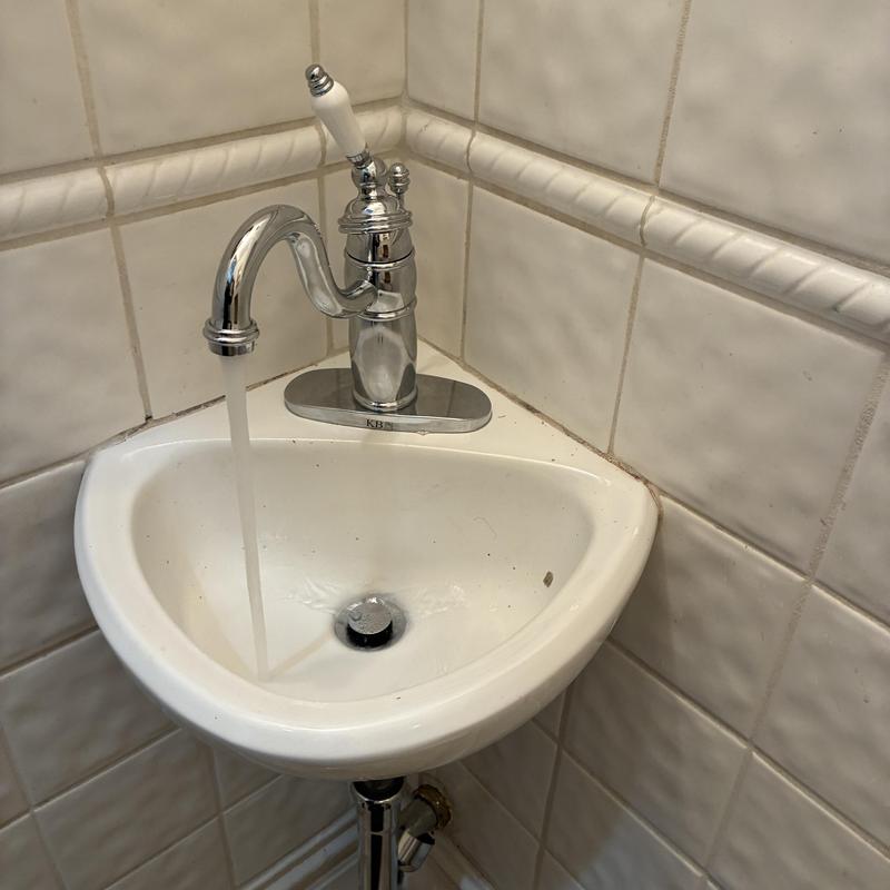 Bathroom sink faucet with water running