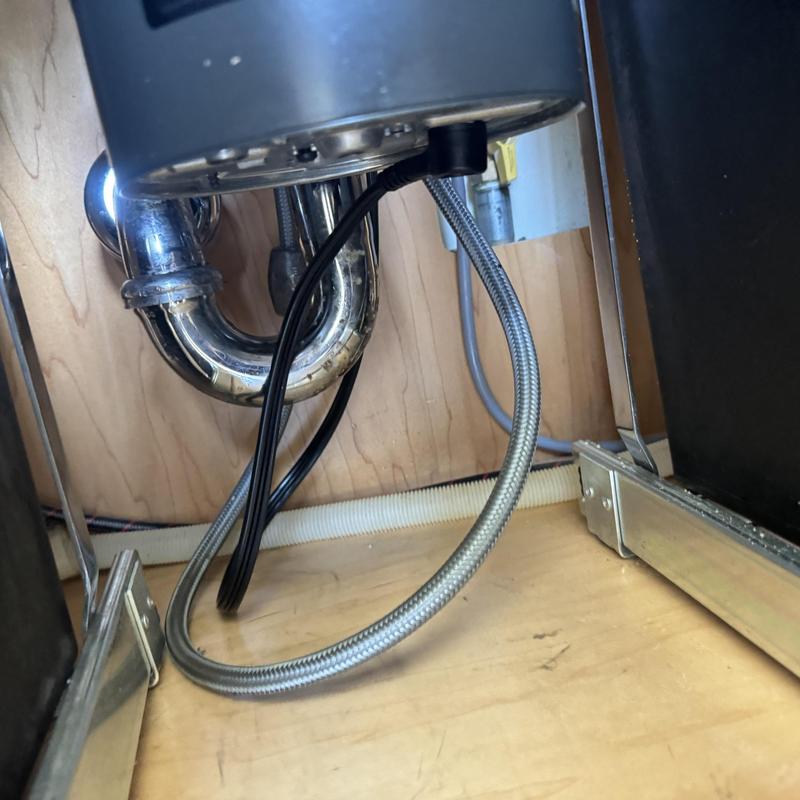 Garbage disposal wiring and plumbing under kitchen sink