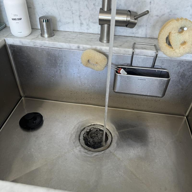 Kitchen sink drain with running water and cleaning tools