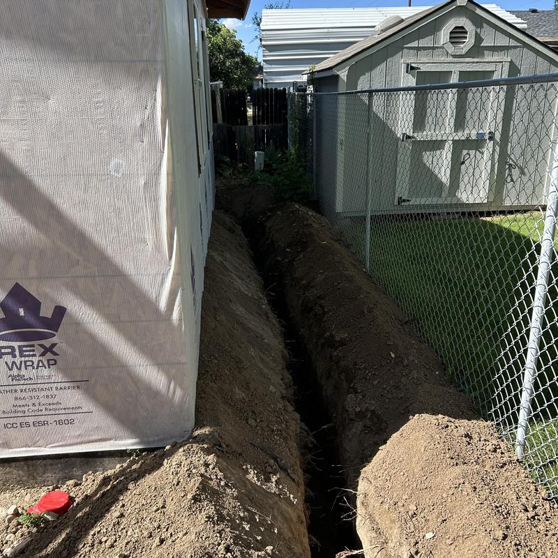 Electrical conduit trench digging beside house and shed Electrical conduit trench digging beside house and shed
