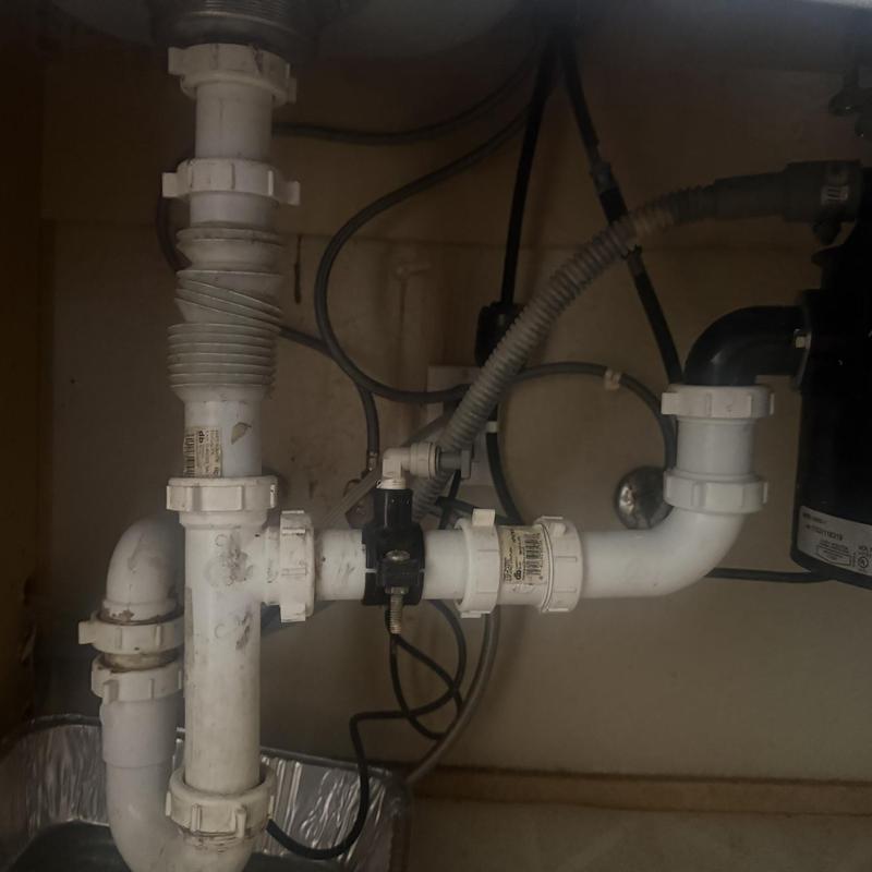 Garbage disposal drain pipes and fittings under sink