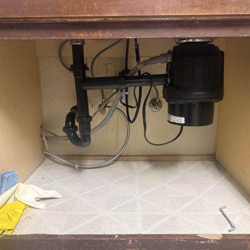 Garbage disposal unit and under-sink plumbing installation