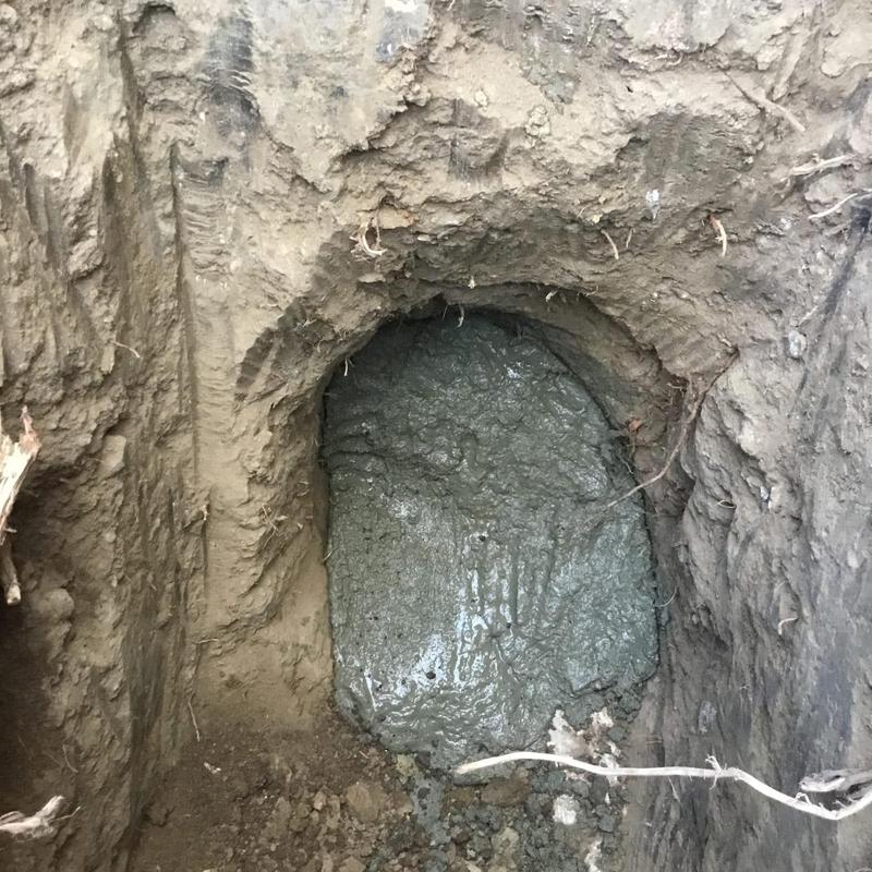 Sewer line spot repair with concrete patch in trench Sewer line spot repair with concrete patch in trench