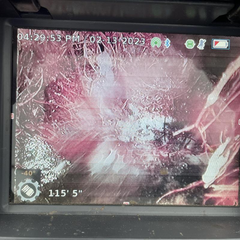 Sewer line camera showing root intrusion and debris Sewer line camera showing root intrusion and debris
