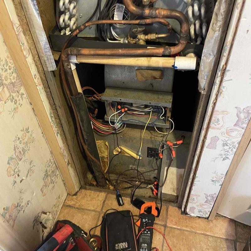 Low voltage wires exposed inside HVAC cabinet with tools Low voltage wires exposed inside HVAC cabinet with tools
