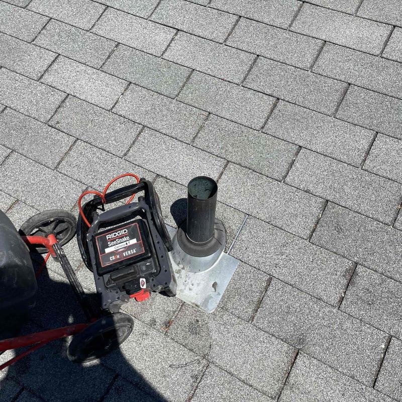 Sewer camera inspection tool on roof vent pipe Sewer camera inspection tool on roof vent pipe