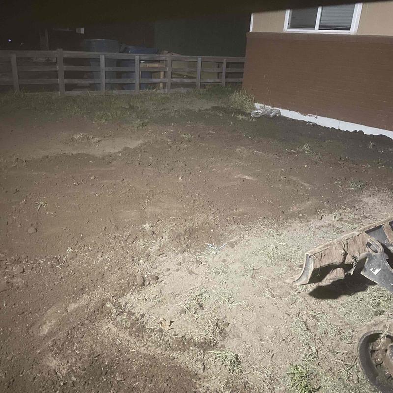Main water line trench excavation near house at night Main water line trench excavation near house at night