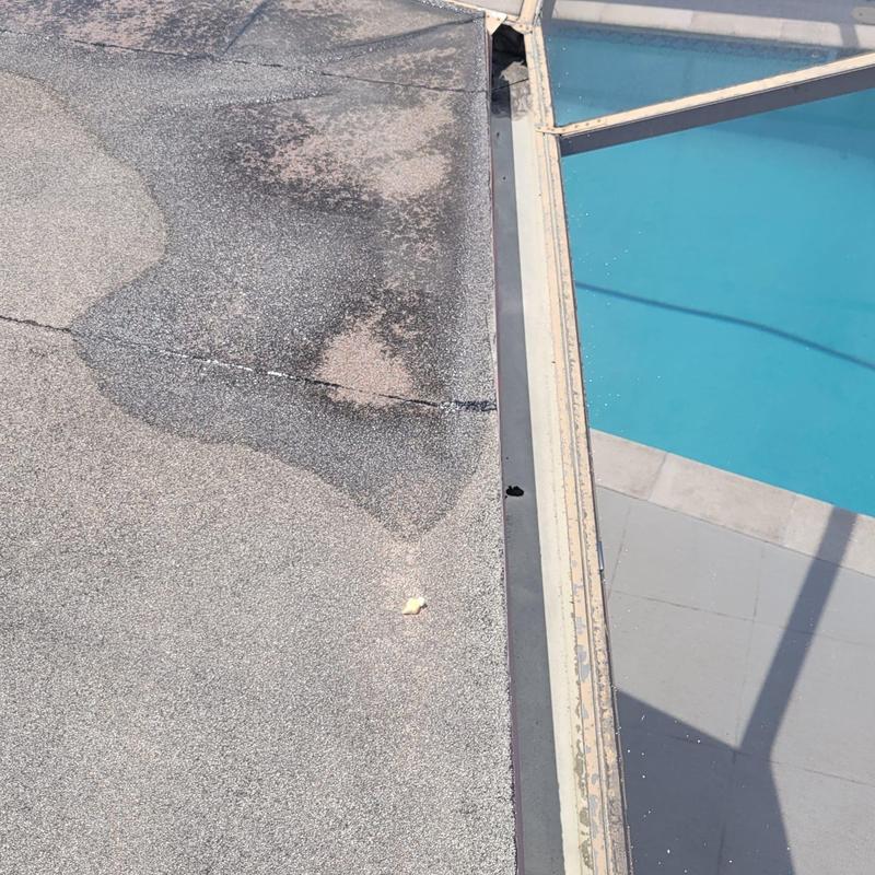 Flat roof with cracking near pool enclosure edge Flat roof with cracking near pool enclosure edge