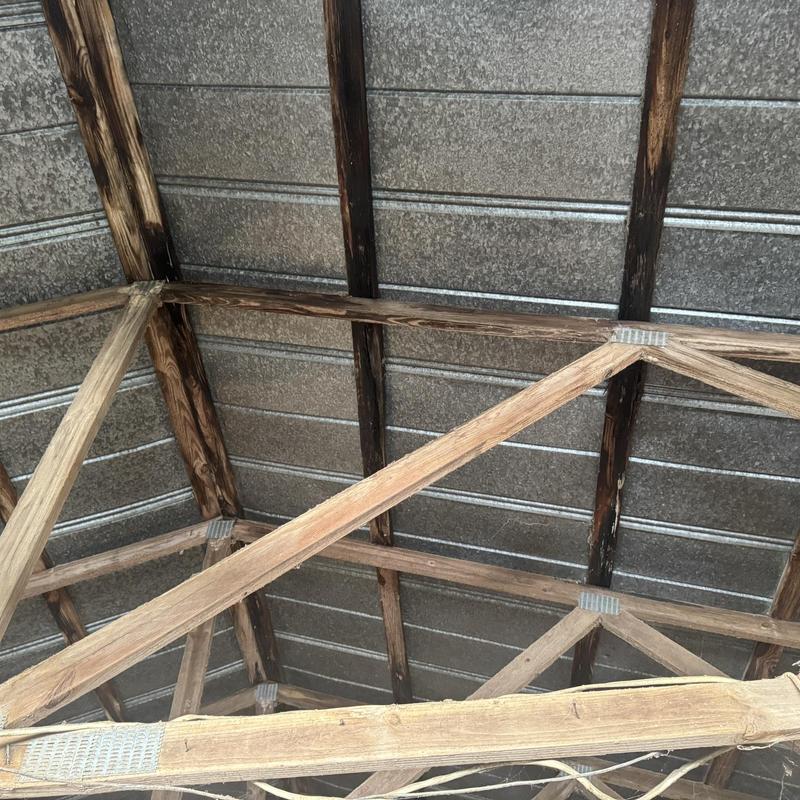 Metal roof with wooden framing structure inspection