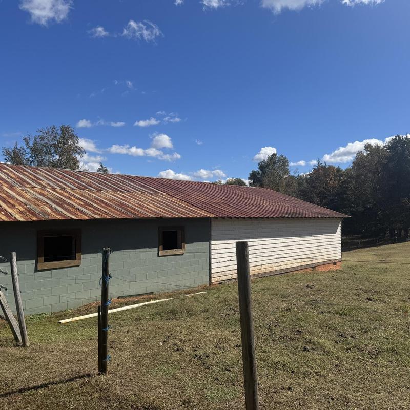Metal roof with rust on farm building exterior