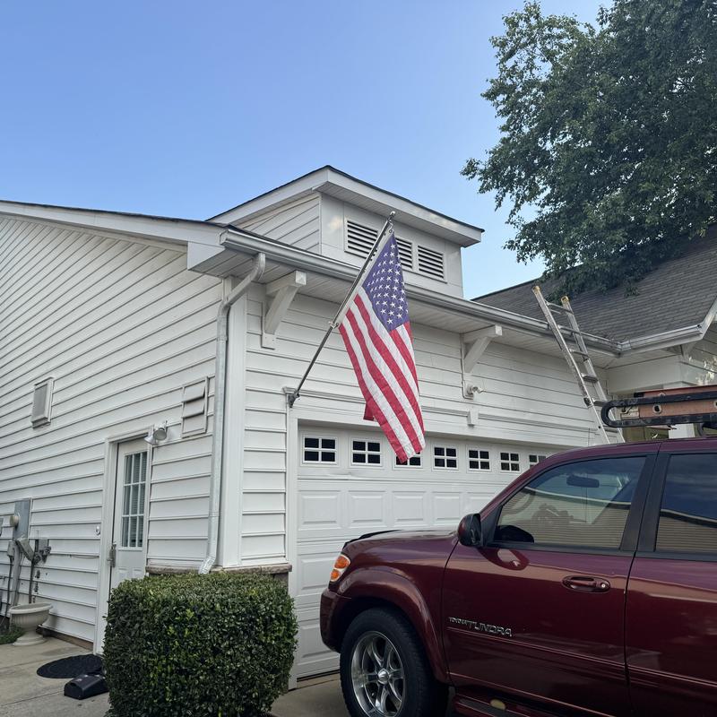 Asphalt shingle roof with ladder and service vehicle