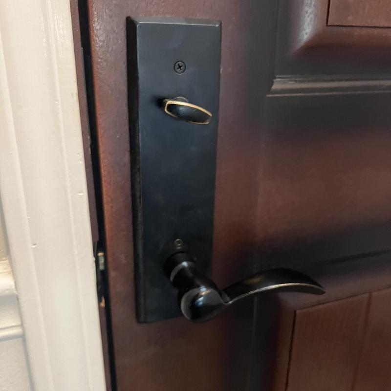 Door knob and deadbolt lock on wooden door