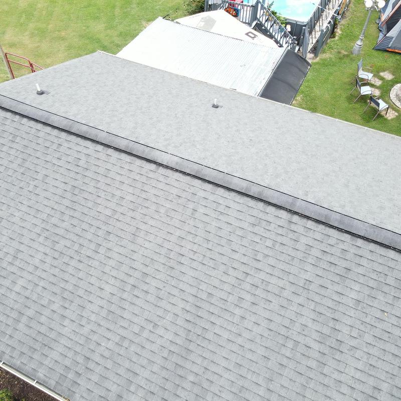 Asphalt shingle roof and metal roof inspection in yard