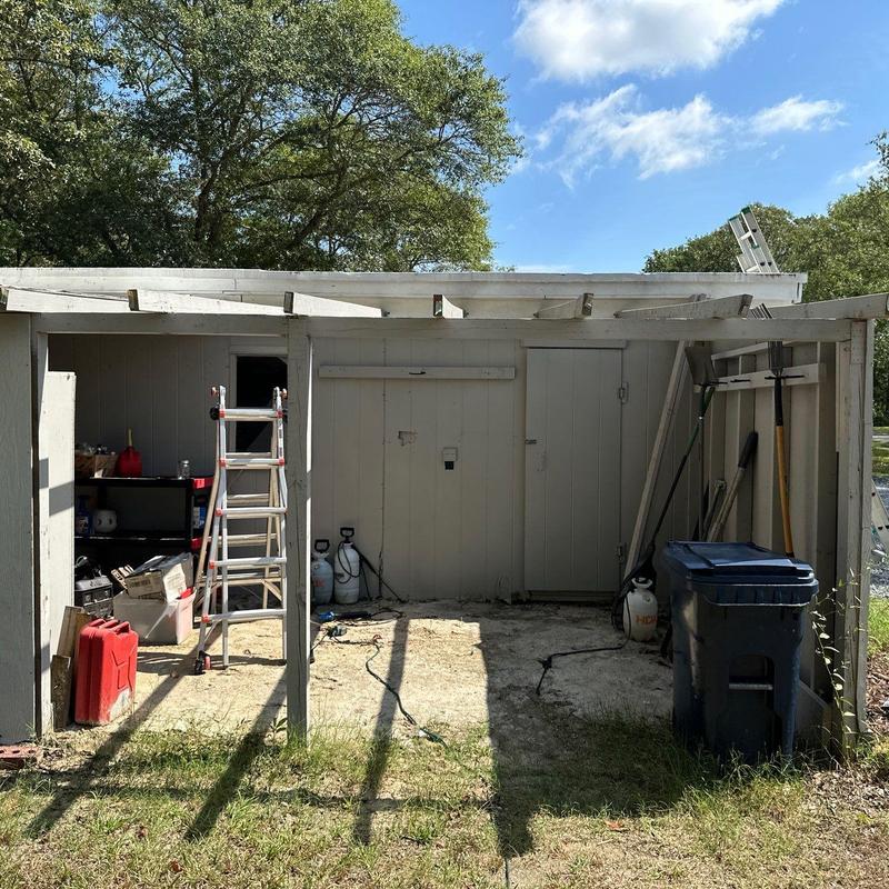 Metal roof and asphalt shingle roof with ladder and tools