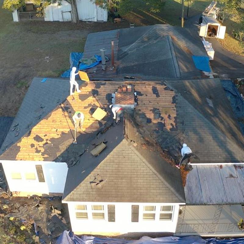 Roof shingles removal and replacement on house roof