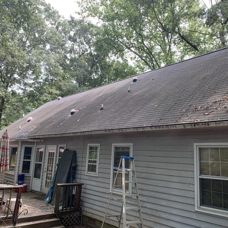 Asphalt shingle roof with ventilation vents and gutters