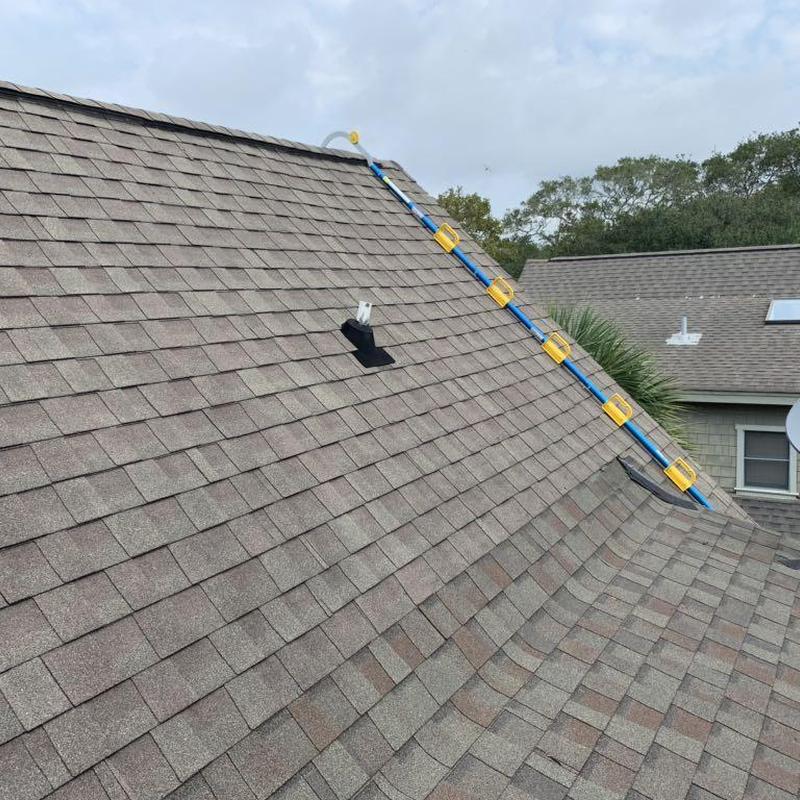 Asphalt shingle roof with ridge vent and safety track