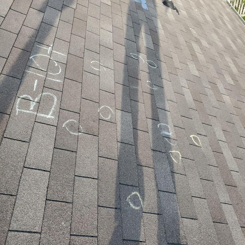 Asphalt shingle roof with chalk markings and shadows