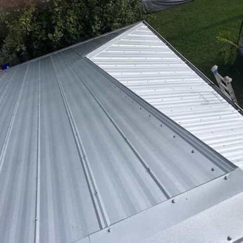 Metal roof panels installation on residential roof Metal roof panels installation on residential roof