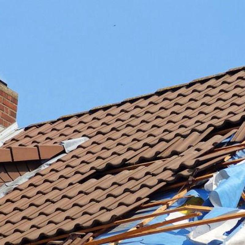Tile roof with broken and missing shingles during repair Tile roof with broken and missing shingles during repair
