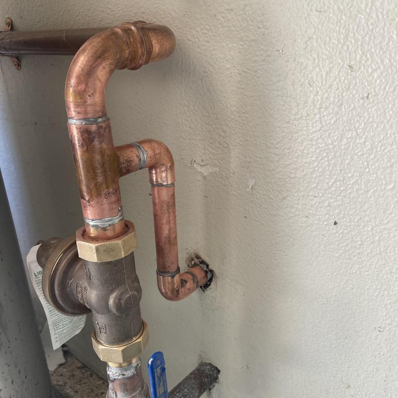 Pressure regulator and copper piping installation on wall