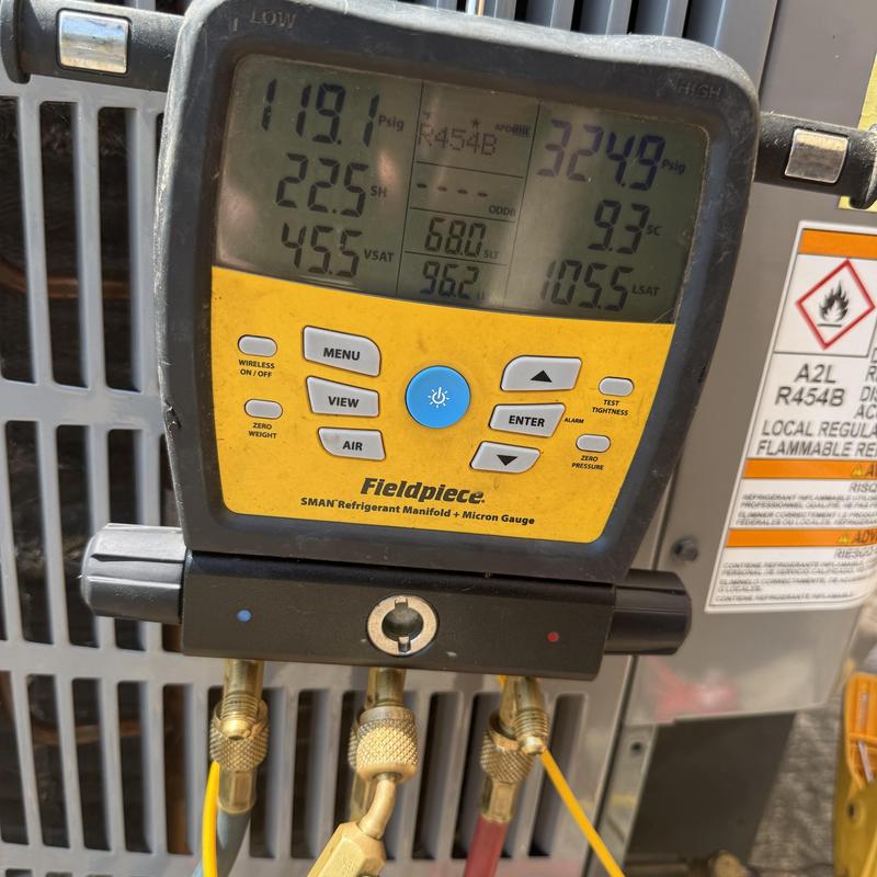 Refrigerant manifold gauge measuring HVAC pressure levels Refrigerant manifold gauge measuring HVAC pressure levels