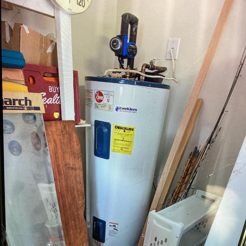 Electric water heater with recirculating pump in garage Electric water heater with recirculating pump in garage