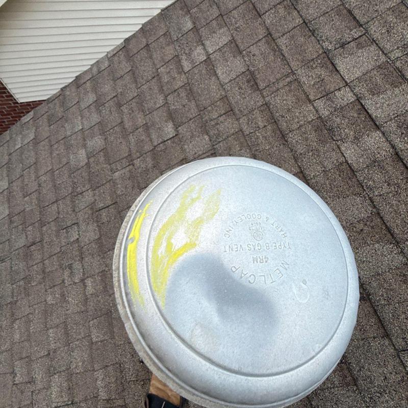 Roofing gas vent with hail damage on shingles