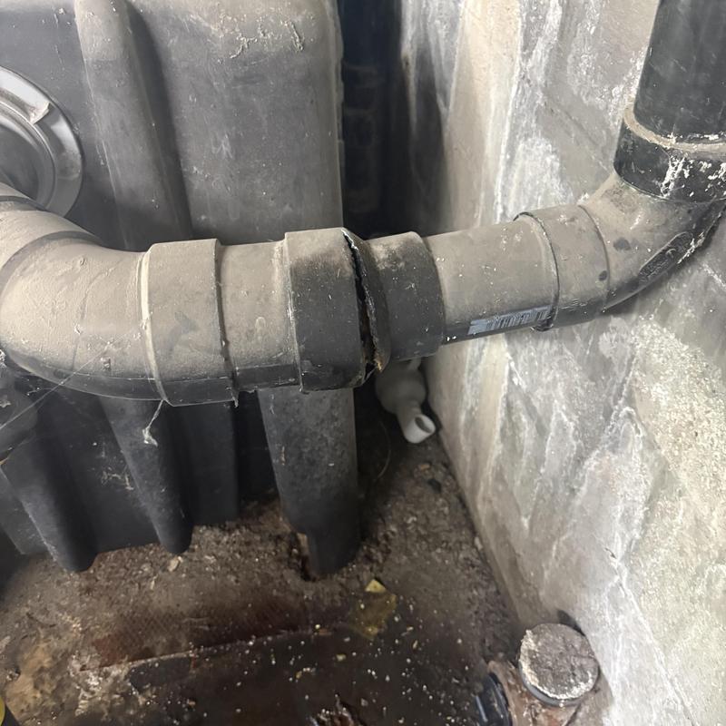 Mainline pipe with visible crack near grease interceptor