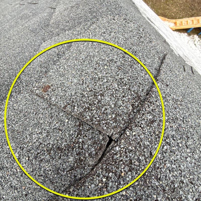 Asphalt roof shingles with hail damage and cracks