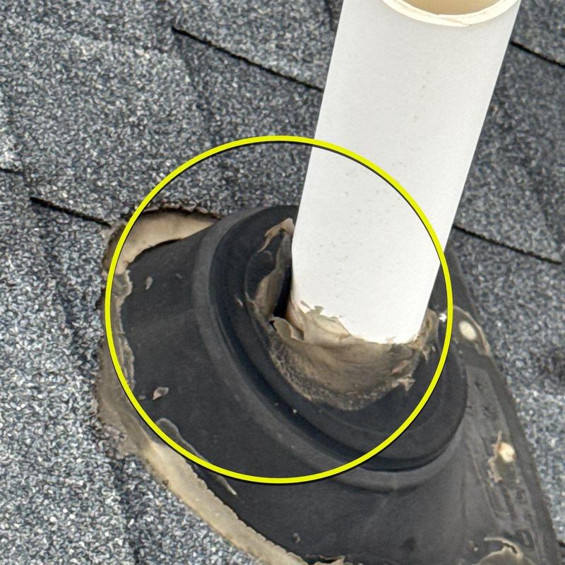 Roof pipe flashing with cracked sealant on shingles