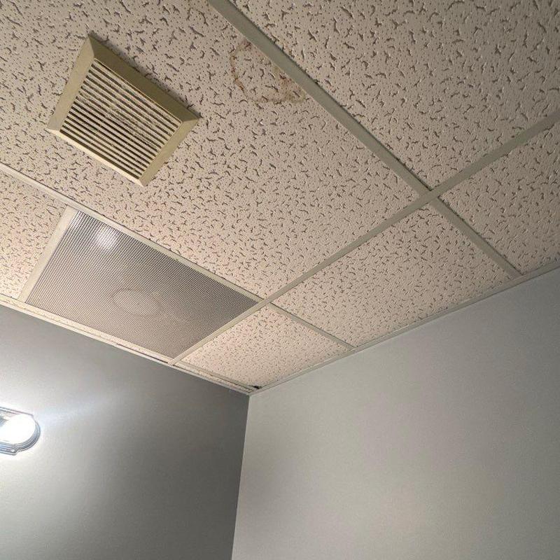 Ceiling vent and water-stained ceiling tiles