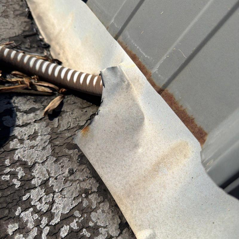 Metal roofing flashing with rust and damage close-up
