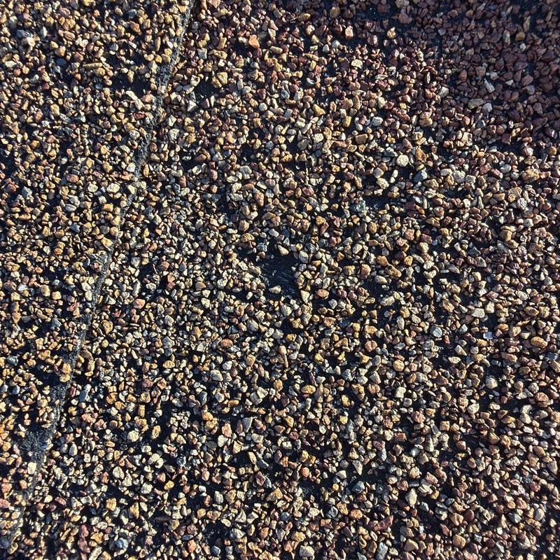 Asphalt shingle roof with hail damage granules