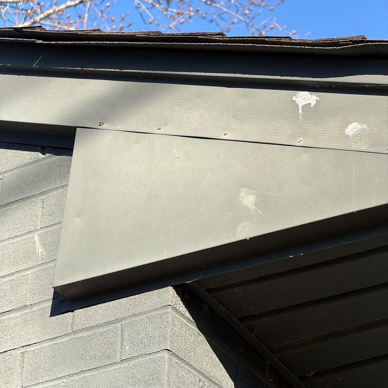 Fascia board with nail heads and paint marks