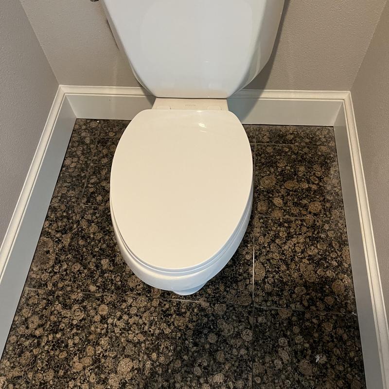 Toilet installation with new supply line on granite floor