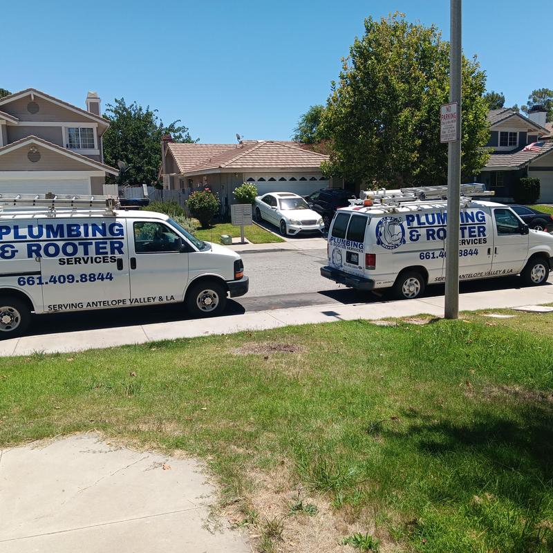 Sewer and drain replacement trucks in residential neighborhood