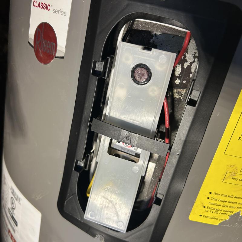 Water heater ignition control panel with wiring exposed Water heater ignition control panel with wiring exposed